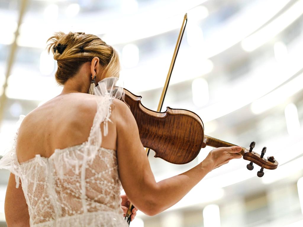 Elegant concert hall interior with ornate ceiling and golden lighting